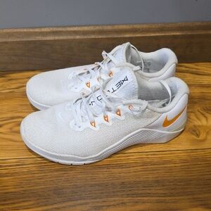 Nike Women's White Trainers with Orange Swoosh Accents